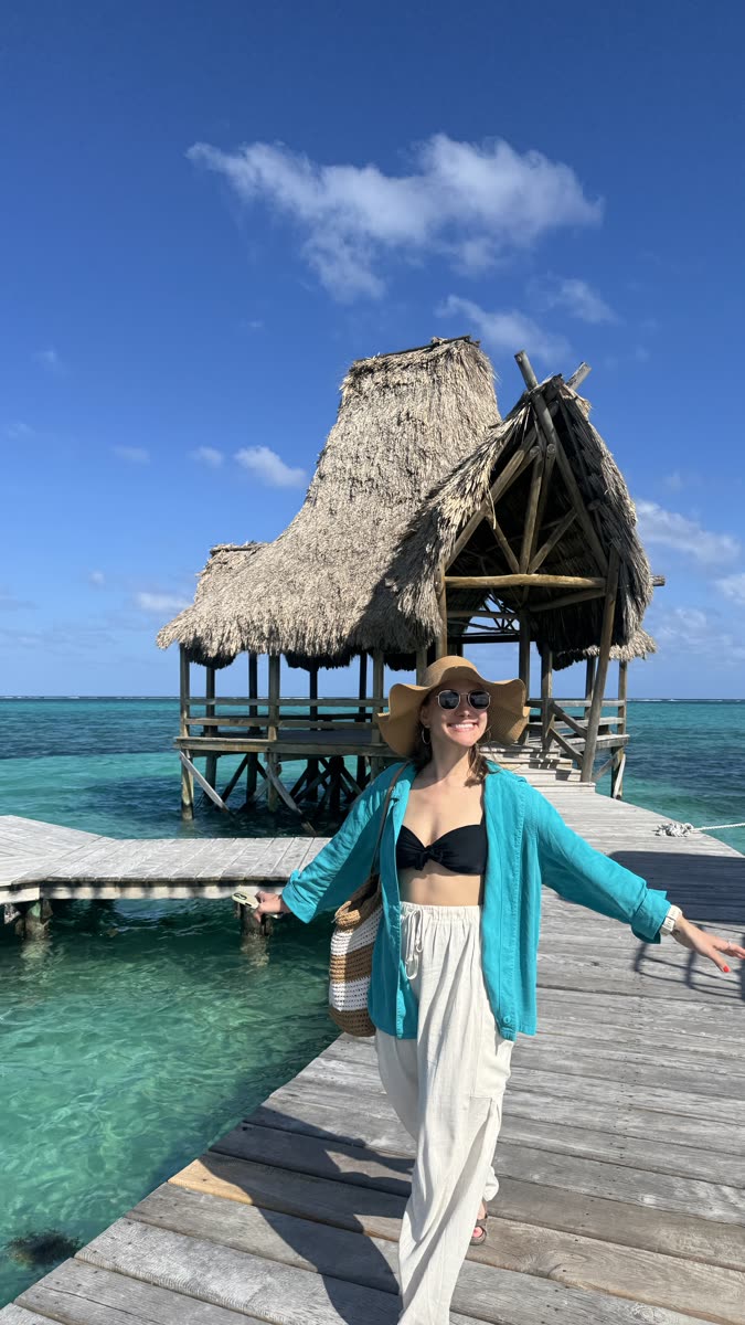 Walking a pier toward an overwater hut